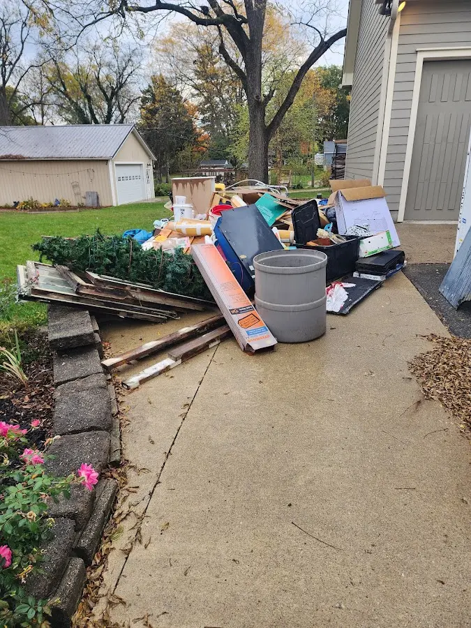 Dumpster being loaded with debris for 12 Yard Dumpster Rental in Brownsville